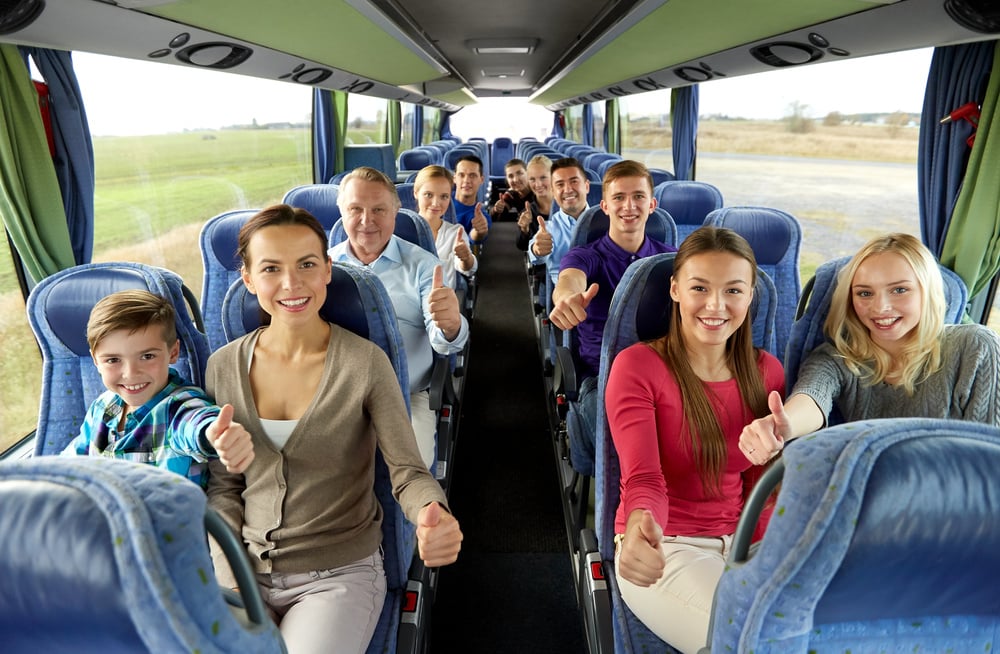 Group of Happy Passengers Travelling by Bus